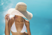 Woman wearing sun hat at poolside