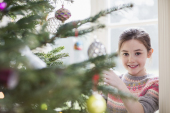 Portrait girl decorating Christmas tree